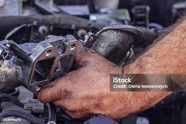 Dirty Greasy Hands Of A Man Repairing The Engine Egr Valve In The Car Close Up Stock Photo - Download Image Now