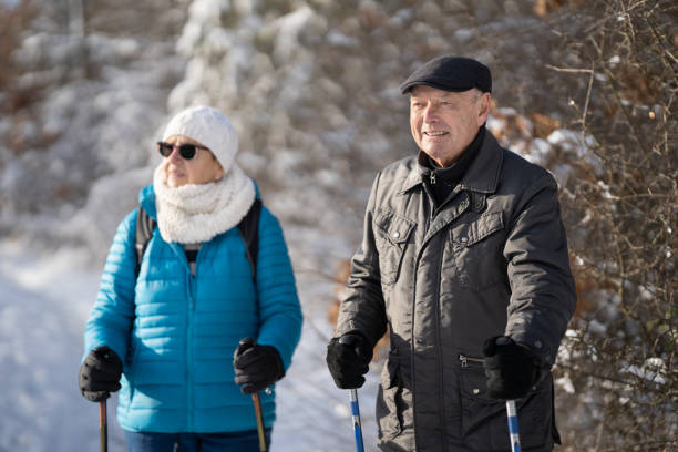 istock Senior Couple on Winter Snow Walk 1358997019