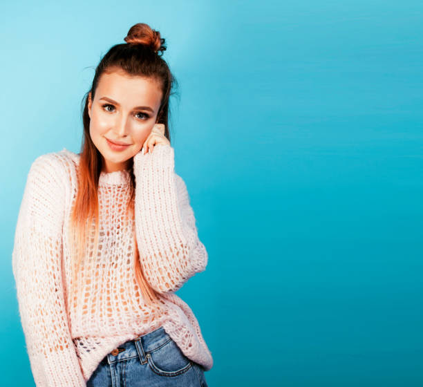 istock young pretty woman cheerful happy smiling, posing on blue backgr 1358997537