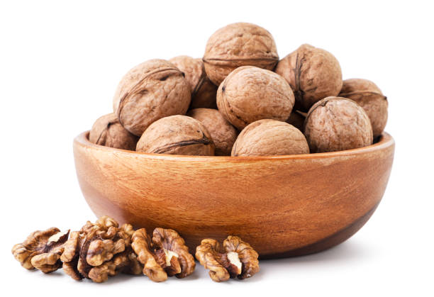 istock Whole walnut in a plate on a white background. Isolated 1358998793