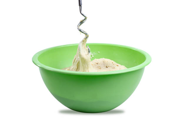 Large bowl with dough on white background, isolated, place for text