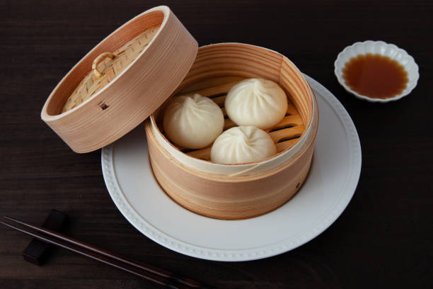 istock xiaolongbao Chinese steamed bun mantou dumpling on wooden table 1359000456