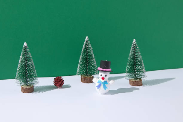 istock Snowman in a pine forest on snow with one pine cone. Christmas scene. 1359003167