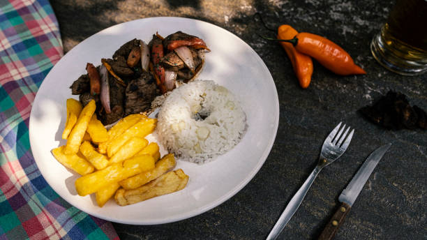 Lomo Saltado (Peruvian Stir-Fried Beef) with French fries stock photo