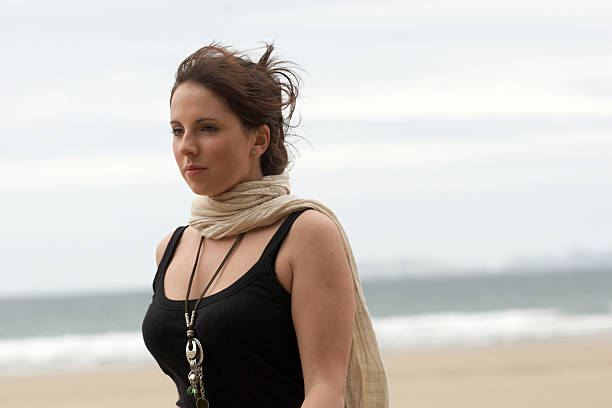 Woman with silk scarf on the beach