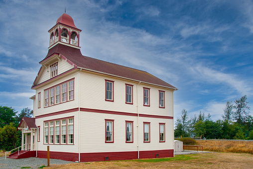The Dungeness School is a historical school house built by the early settlers in the area.  In 1892 a meeting was held to create a bond and plan the two-story school house.  The school was opened in February of 1893.  The school had 73 students when it opened and only one teacher who lived on the second floor.  After the consolidation of the Sequim and Dungeness School Districts in 1955 the school was closed.  In 1971, the school was designated a Washington State Historical Site and on May 19, 1988 the building was listed on the National Register of Historic Places.  The Dungeness School is located in Dungeness, Washington State, USA.