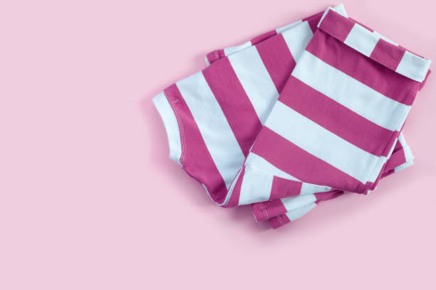 istock Striped pink T-shirt on paper background. 1359013269