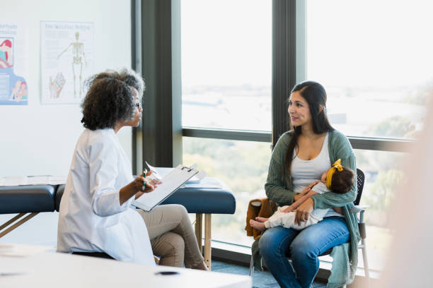 istock Female pediatrician gestures while talking with new mom 1359015941