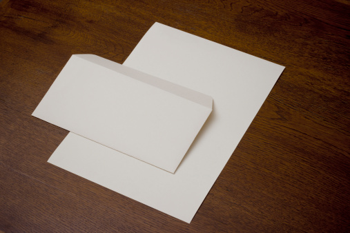 Composition of wood on the table, envelopes and paper.