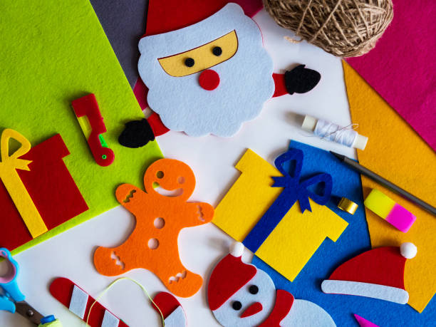 istock Hobby and colorful felt crafts. Workspace view. Sheets and crafts made of felt, scissors, threads and a needle for needlework. 1359017839