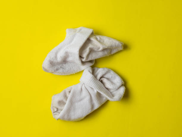 istock crumpled white dirty socks on yellow background 1359017856