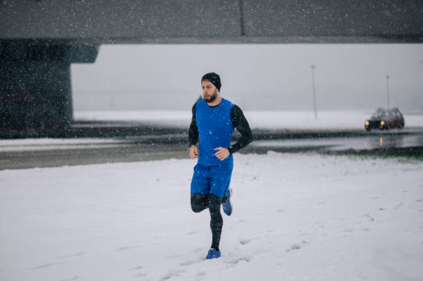 istock Man running outside on a cold winter day. 1359020172