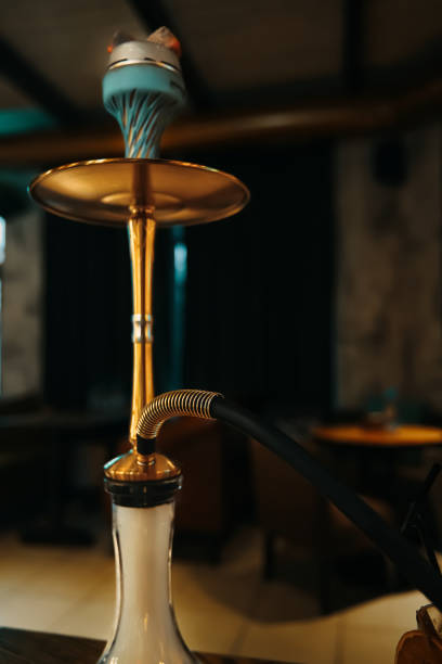 istock Gold hookah on table in lounge cafe. 1359021265