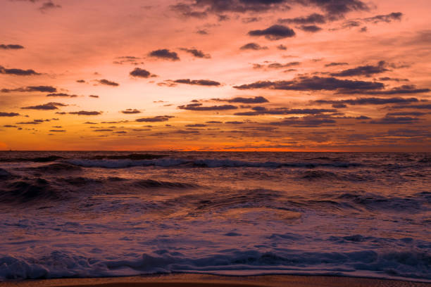 istock Waves breaking on the beach at Sunrise 1359023628