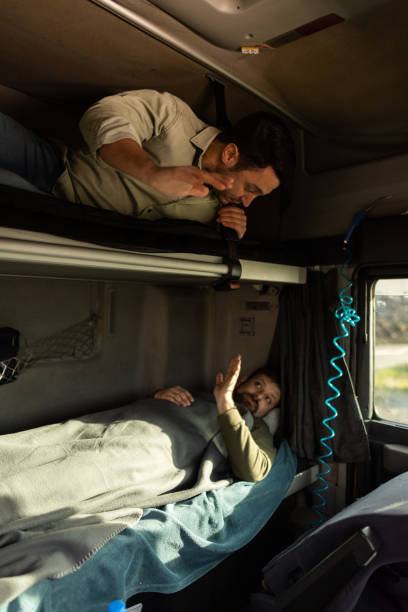 istock Two truck drivers taking a break and going to sleep 1359025493