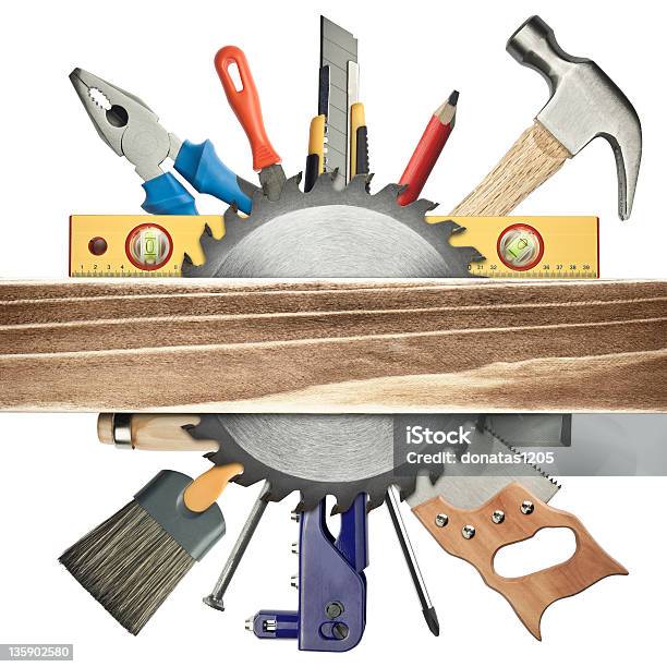 Circle Of Building Tools Behind Saw Blade And Wood Plank Stock Photo - Download Image Now