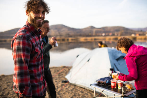 a happy young man camping with his family - camping tent offspring 60s imagens e fotografias de stock