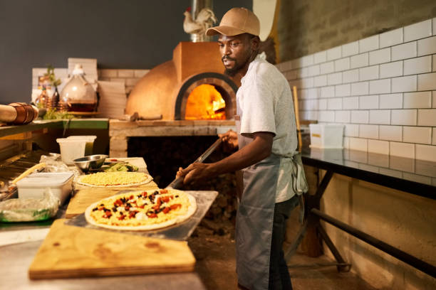 伝統的なピザを準備するレストランのキッチンで働く男 - pizza pizzeria restaurant waiter ストックフォトと画像