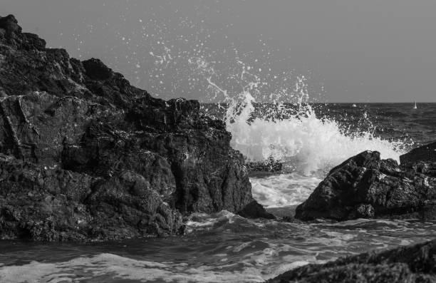 istock Sea crashing on to rocks 1359029810