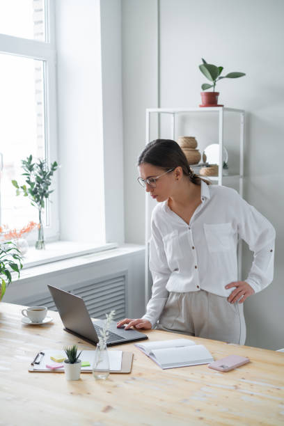 istock Businesswoman standing over office desk. 1359033246