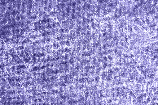 Trendy Color of Year 2022. Texture of a violet stone-washed denim fabric as a background