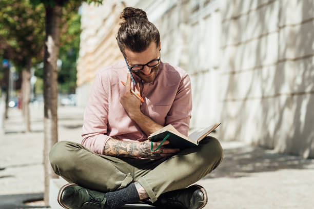 istock Student learning and talking on the phone on the street 1359036328