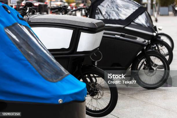 Modern Cargo Bikes In A Row In A City Stock Photo - Download Image Now - Cargo Bike, Bicycle, City