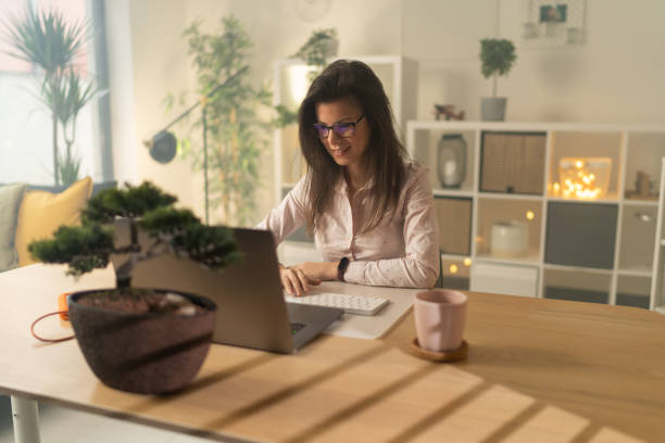 istock Young woman sitting in office and working on laptop 1359038041