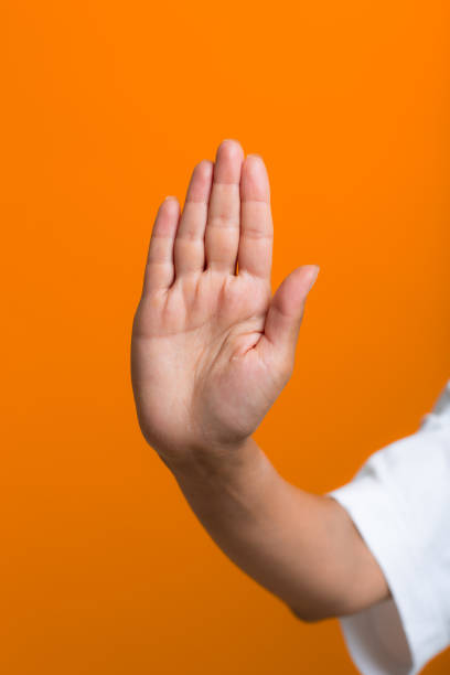 istock Close up woman hand with stop gesture palm. 1359043465