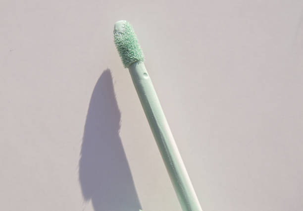 Close-up of a brush of green concealer for correcting skin imperfections, on a white background Close-up of a brush of green concealer for correcting skin imperfections, on a white background. concealer stock pictures, royalty-free photos & images