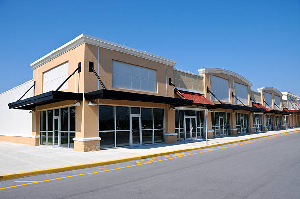 Beige shopping center with available retail space New Shopping Center with Retail and Office  Space available for sale or lease consumerism stock pictures, royalty-free photos & images