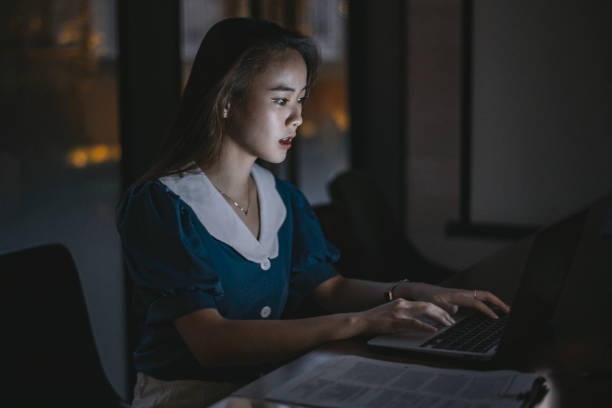 istock Young businesswoman doing work alone at night 1359045694