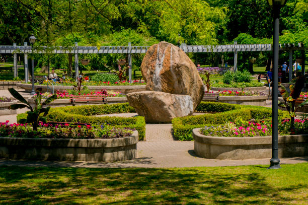 Landscaped Park With Plants Trees Flowers And Stone Fountain stock photo