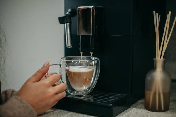 istock woman 30 years old makes coffee at home 1359052067
