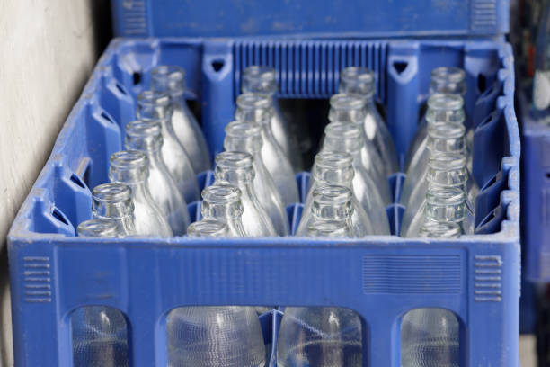 istock glass bottles in blue plastic crate. Concept : Empty glass bottle waiting for refill water. 1359052112