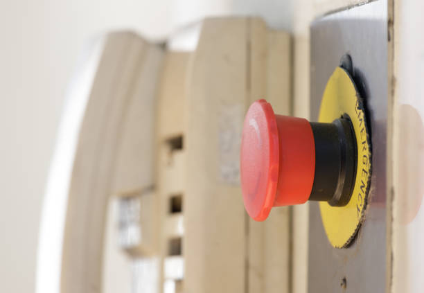 red emergency button with blur telephone background near factory elevator.