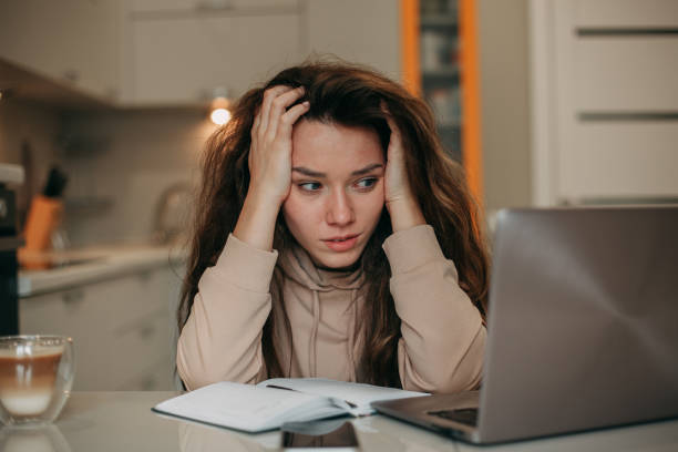 istock Young girl working on laptop at home 1359054454