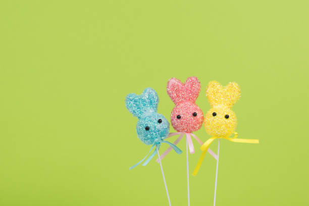 istock Three colorful Easter bunnies on a green background. 1359054620