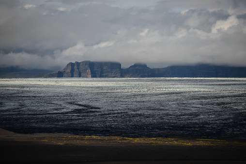 Skeidararjökull glacier and cloud-covered, jagged mountains seen from the Skaftafellsheidi plateau, Skaftafell, Vatnajökull National Park, South Iceland