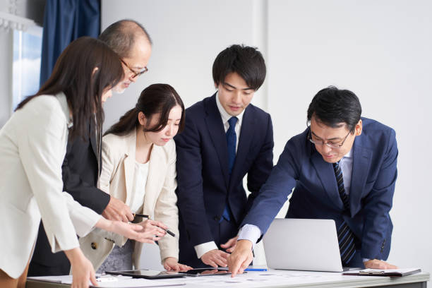 istock Asian business woman explaining at a meeting 1359056744