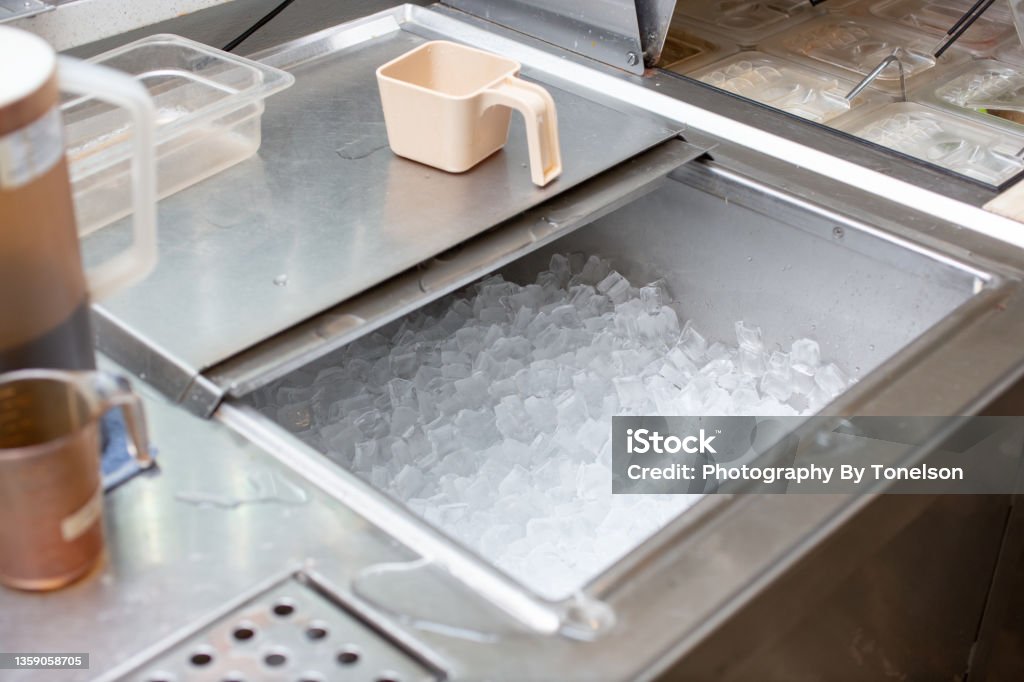 ice bin A view of a commercial grade ice storage bin, seen at a local drink restaurant. Ice Stock Photo