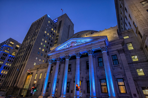 Montreal, Canada - November 19, 2021: Exterior view of Bank of Montreal Building at Place d'Armes at night.