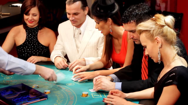People having fun at the Blackjacks table in casino.