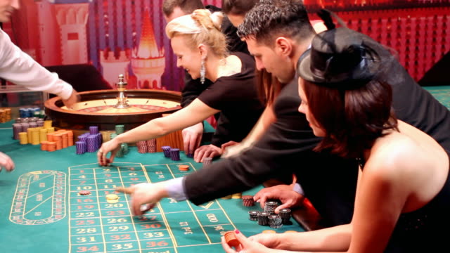 Lucky attractive people having fun at casino.