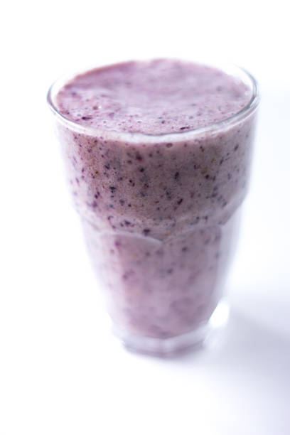 istock Blueberry Smoothie in Periwinkle Color, White Background 1359062694