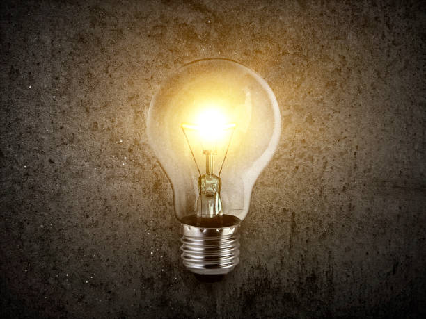 istock concept creativity with bulbs that shine glitter on Concrete floor background 1359063650