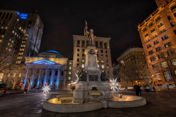 The Place d'Armes in Montreal, Quebec, Canada Montreal, Canada - November 19, 2021: The Place d'Armes square at night, in preparation for the month of December with illuminated Christmas decorations. Notre Dame Basilica in the background, The Monument à Maisonneuve is a work by Louis-Philippe Hébert in memory of Maisonneuve, founder of Montreal, installed in 1895 in the center of Place d'Armes in Old Montreal. place darmes montreal stock pictures, royalty-free photos & images