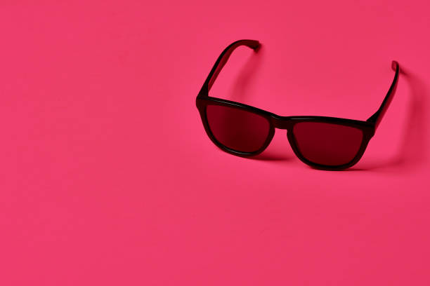 istock Black sunglasses on a Mexican pink background. 1359063806