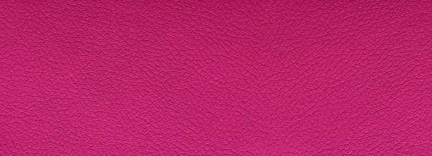 istock Clean magenta leather fullframe texture. Empty red leatherette closeup macro background 1359064804