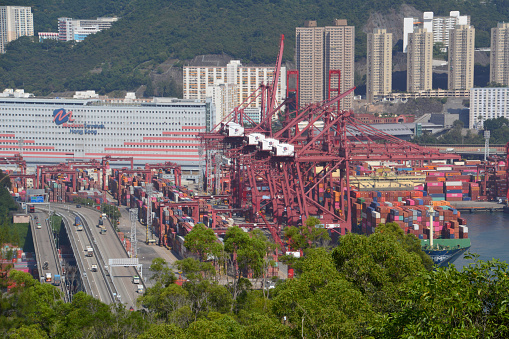 High angle view of container ship loading cargo containers at the busy Hong Kong port.
